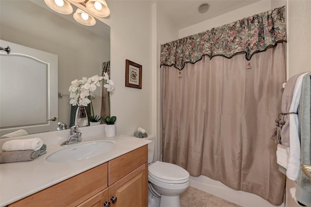 bathroom featuring tile patterned flooring, vanity, and toilet