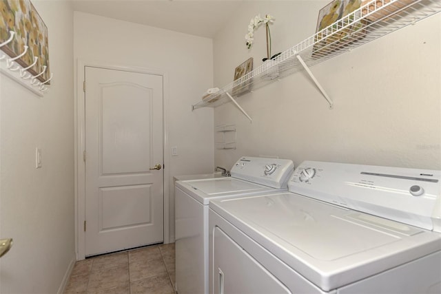 laundry room with light tile patterned floors and washing machine and clothes dryer