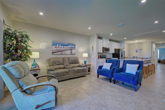 living room with recessed lighting, visible vents, and light tile patterned floors