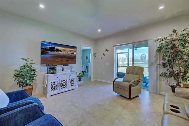 living room featuring baseboards, visible vents, and recessed lighting