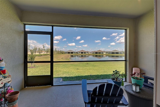 sunroom / solarium featuring a water view