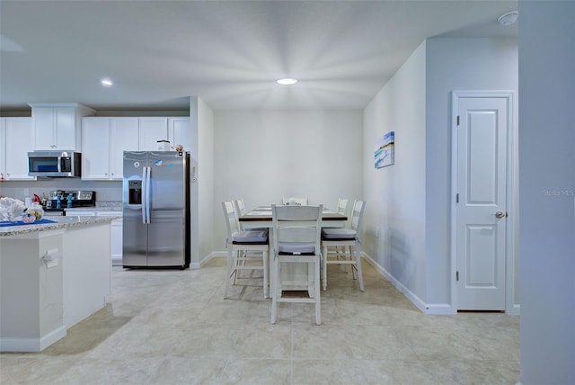 dining space featuring baseboards and recessed lighting