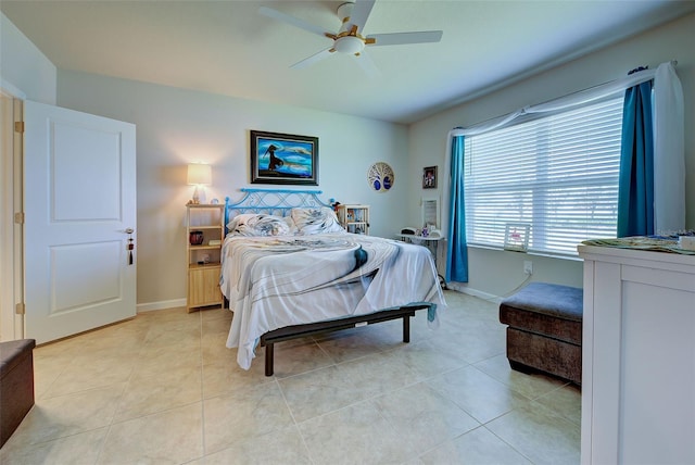 bedroom with light tile patterned floors, baseboards, and a ceiling fan