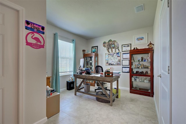 office featuring visible vents, baseboards, and light tile patterned flooring