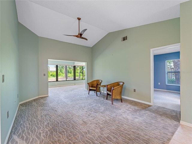 living area featuring ceiling fan, vaulted ceiling, and carpet