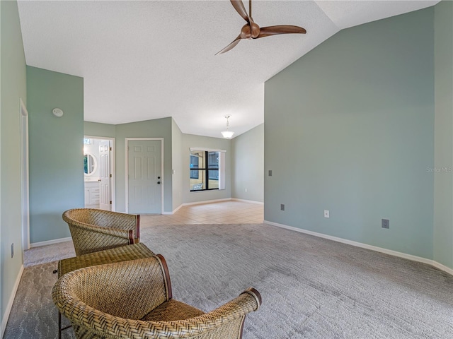 tiled living room with ceiling fan, a textured ceiling, and vaulted ceiling