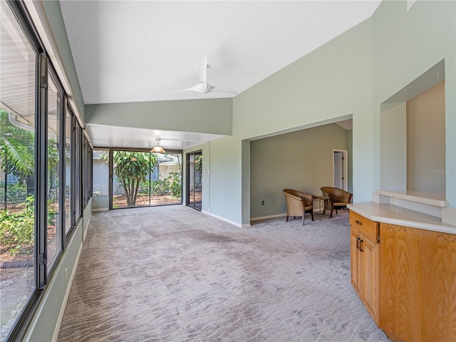 sunroom with ceiling fan and lofted ceiling