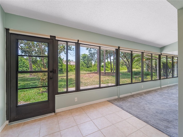 interior space with light tile patterned floors and a textured ceiling