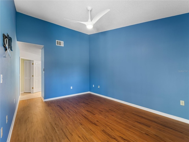 unfurnished room with ceiling fan and wood-type flooring