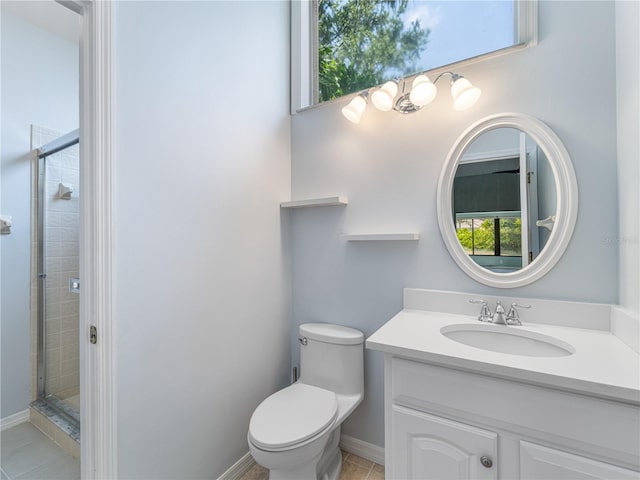 bathroom featuring vanity, a shower with door, toilet, and tile patterned flooring