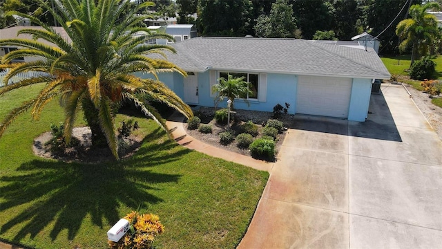 view of front of home featuring a garage and a front yard