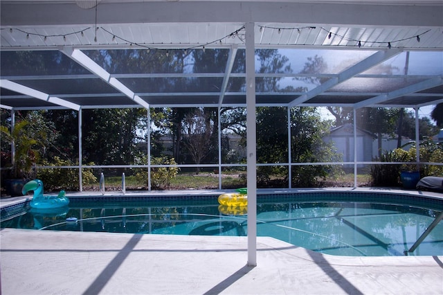 view of pool featuring a patio and glass enclosure