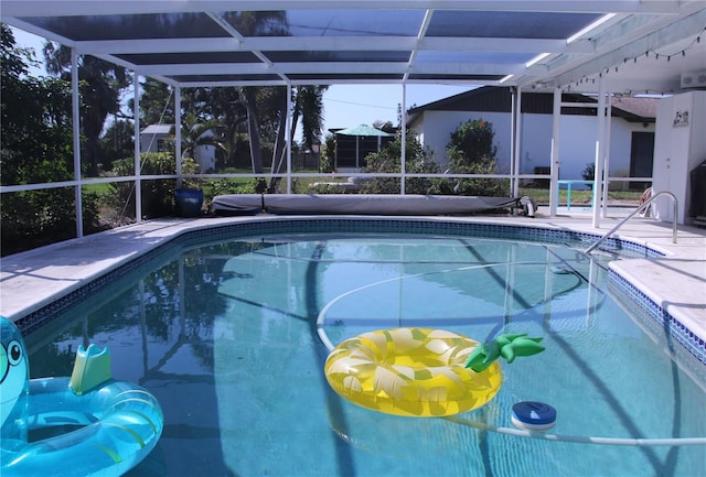 view of swimming pool with a lanai and a patio area