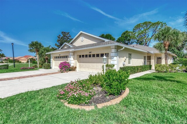 view of front facade featuring a front lawn and a garage