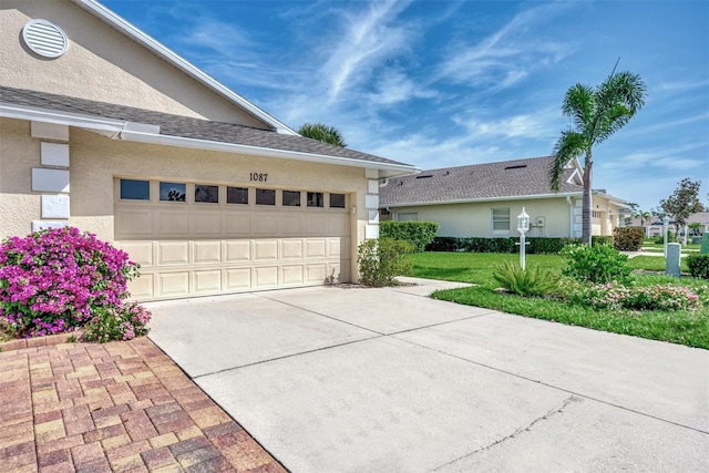 view of property exterior featuring a lawn and a garage