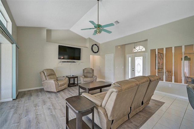 living room featuring high vaulted ceiling, ceiling fan, and light tile patterned flooring