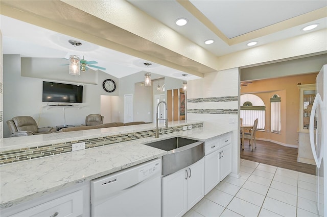 kitchen featuring ceiling fan, tasteful backsplash, light wood-type flooring, and white appliances