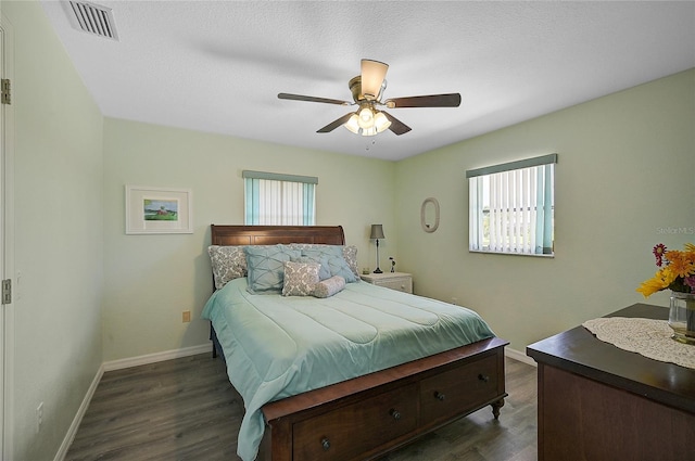 bedroom with ceiling fan and dark wood-type flooring