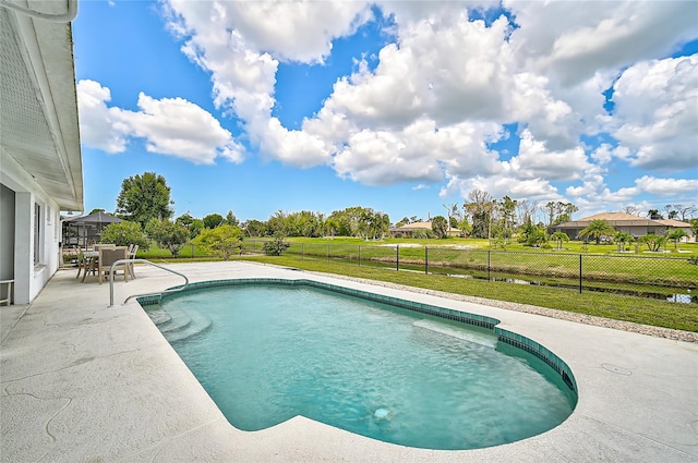 view of swimming pool featuring a patio and a yard