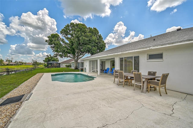 view of pool with a patio area and a yard