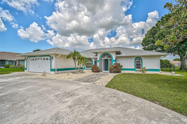 single story home featuring a front lawn and a garage