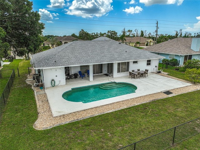 view of swimming pool with a patio and a yard