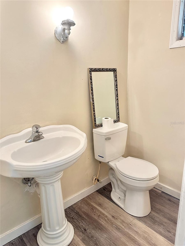 bathroom featuring hardwood / wood-style floors and toilet