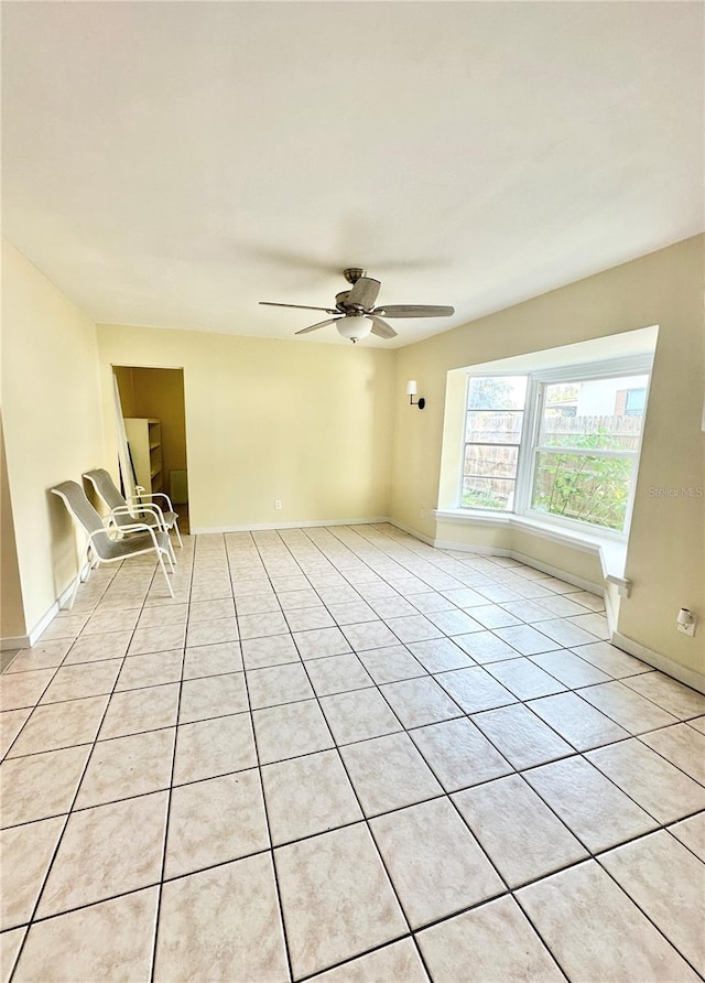 tiled empty room with ceiling fan