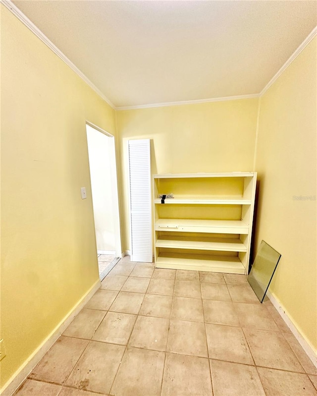 interior space with light tile patterned floors and ornamental molding