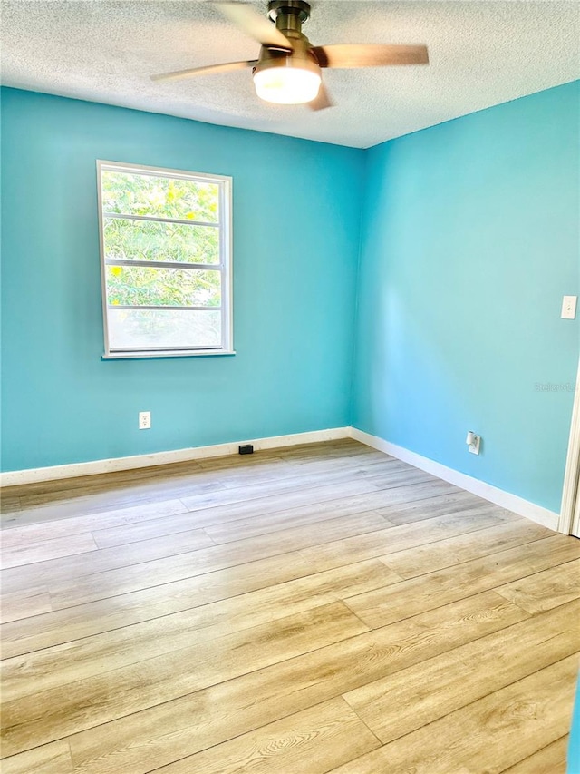 unfurnished room featuring a textured ceiling, ceiling fan, and light hardwood / wood-style floors