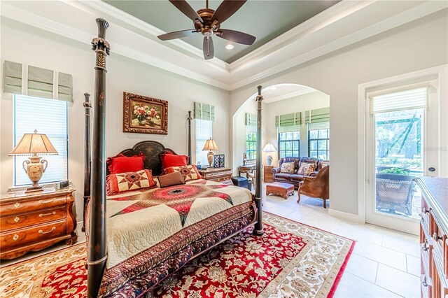 bedroom featuring crown molding, light tile patterned floors, access to outside, a tray ceiling, and ceiling fan