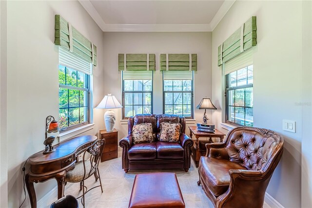 living room with a wealth of natural light, crown molding, and light tile patterned floors