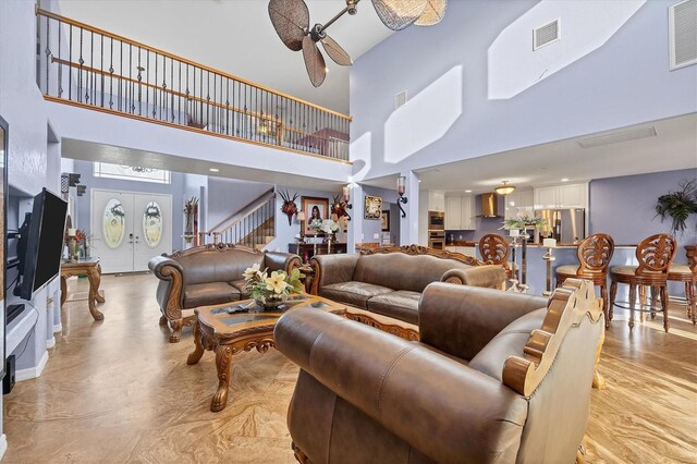 living room with ceiling fan and french doors