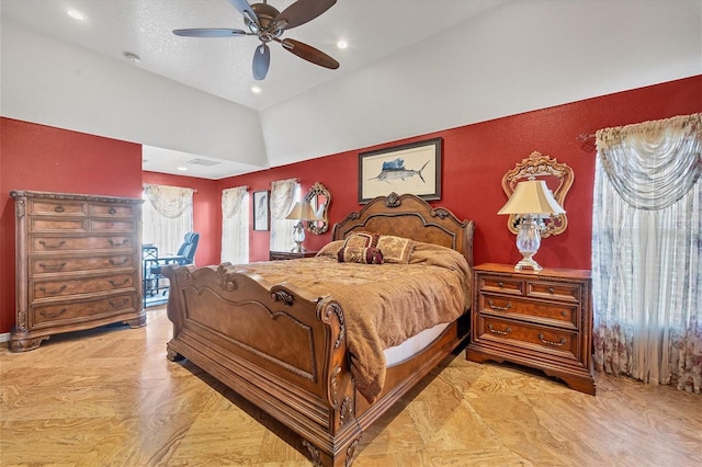 bedroom with ceiling fan, light parquet flooring, and a textured ceiling