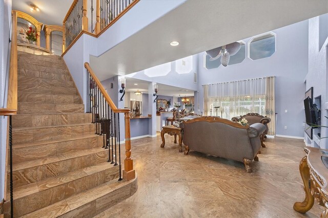 living room with a high ceiling and tile patterned flooring