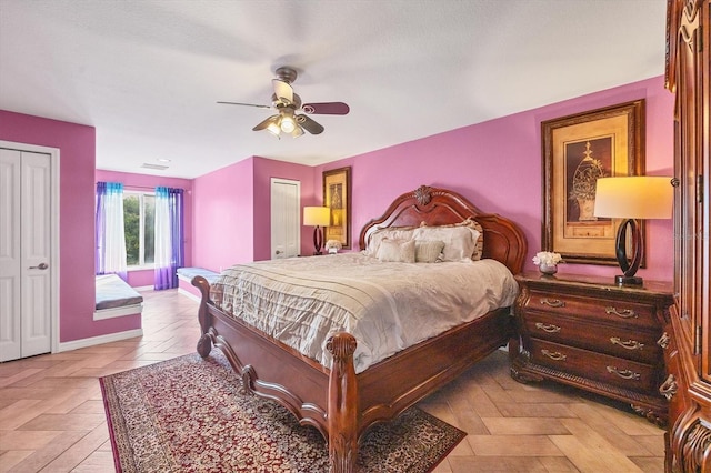 bedroom featuring ceiling fan and two closets