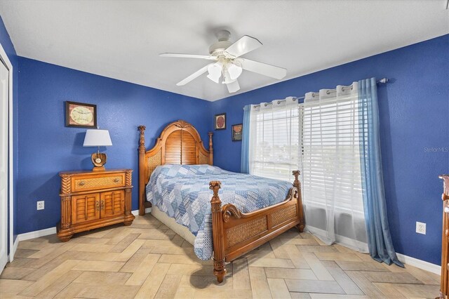 bedroom with ceiling fan and light parquet floors