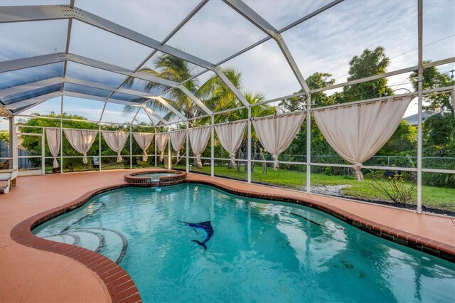 view of pool featuring an in ground hot tub, a patio area, and a lanai