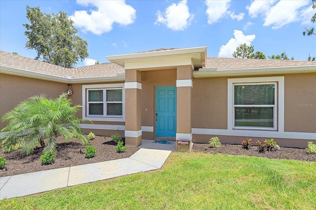 doorway to property featuring a yard