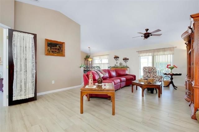 living room featuring ceiling fan, vaulted ceiling, and light hardwood / wood-style flooring