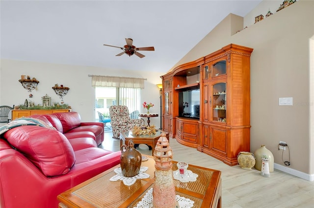 living room with light wood-type flooring, vaulted ceiling, and ceiling fan