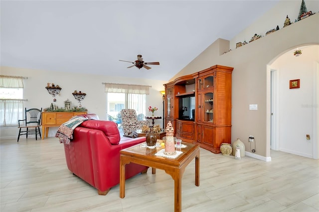 living room featuring ceiling fan, light hardwood / wood-style flooring, and lofted ceiling