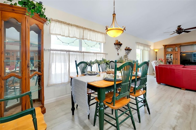 dining area with ceiling fan, light hardwood / wood-style floors, and lofted ceiling