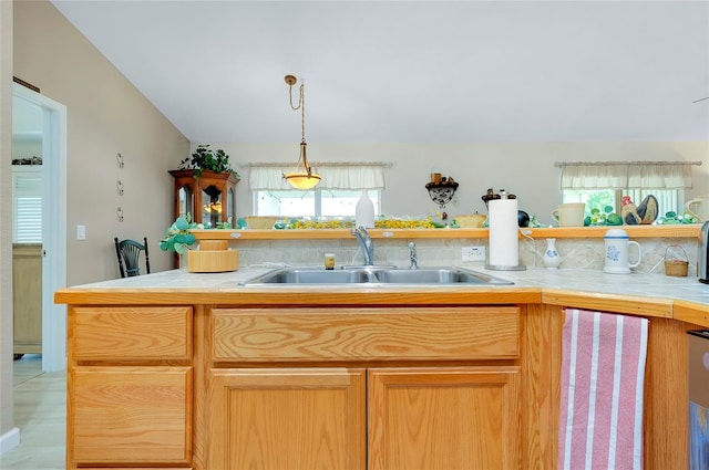 kitchen featuring light tile patterned floors, a wealth of natural light, sink, and tile countertops