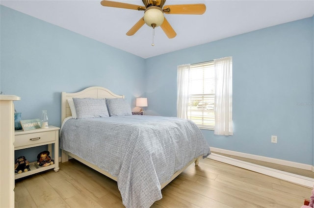 bedroom with light wood-type flooring and ceiling fan