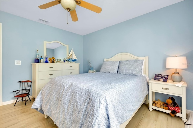 bedroom with ceiling fan and light hardwood / wood-style flooring