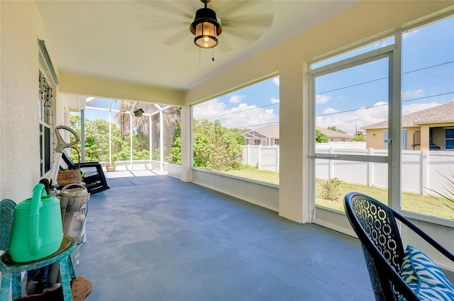 sunroom featuring ceiling fan and plenty of natural light