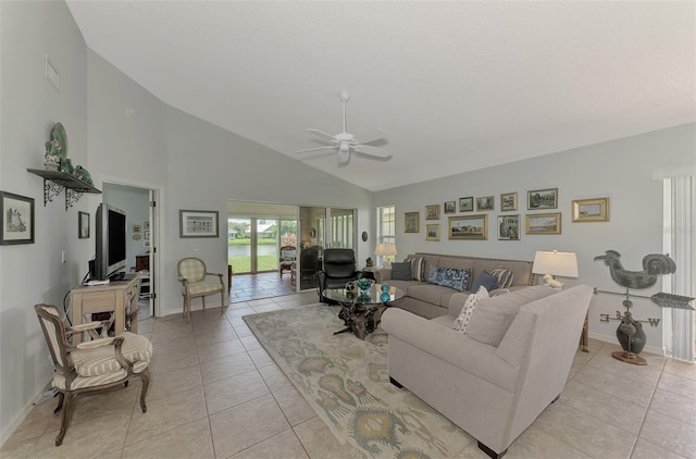 living room featuring high vaulted ceiling, ceiling fan, and light tile patterned floors