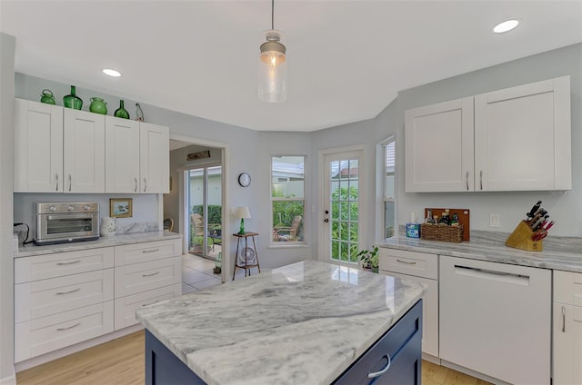 kitchen featuring white cabinetry, a kitchen island, dishwasher, and decorative light fixtures