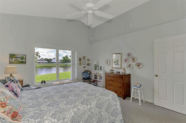 bedroom featuring carpet, vaulted ceiling, a water view, and ceiling fan